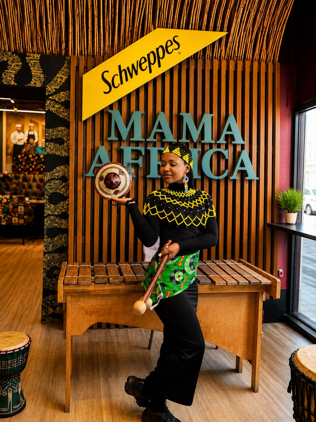 A Mama Africa performer in traditional dress by the marimba