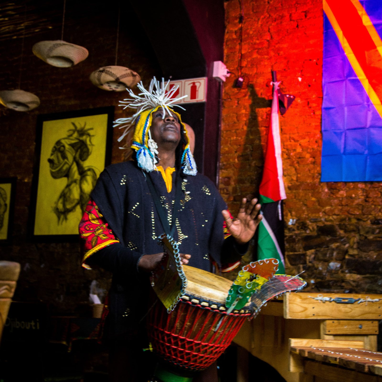 Performer in traditional headdress with drums